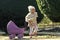 Child and childhood lifestyle. Girl walking with vintage doll stroller on sunny day