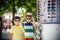 A child and a choice of sunglasses. Two little boys are standing in sun-proof glasses against the background of a shop window with