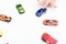 Child chooses his favourite toy car from selection of toys