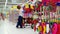 Child choosing a new toy car in market, plastic products, huge shop full of colourful toys