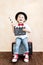 Child with clapper board playing at home