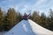 Child climb the hill with a tube for descent. Children ski in the winter with a slide on the tubing. kid runs to hill and sledding