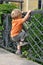 Child climbing fence