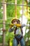 Child climbing on high rope park. Small boy enjoy childhood years. Artworks depict games at eco resort which includes