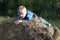 Child climbing onto stack of straw