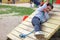 a child is climbing a tightrope in the playground