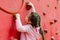 The child  climbs the climbing wall at the sports playground