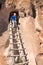 Child climbs the ladder out of Cavate, called Cave Kiva. Bandel