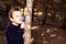 Child closely observes the trunk of a sick tree with a magnifying glass