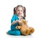 Child with clothes of doctor examining teddy bear