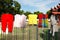 Child clothes and rags drying on a fence