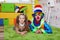 Child and clown lie on a carpet in the nursery.