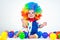 Child clown with a red nose multicolored wig in with balls