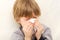 Child cold flu illness tissue blowing runny nose