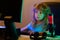 Child with computer late at night. Neon blue light. Little hacker, young programmer.