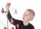 Child is concentration about decorating Metal wire Christmas tree, with glass Ornaments