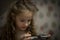 Child Concentration, Female Digital Native Looking Down Holding Technology. A concentrated female digital native looking down