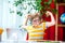 Child with confidence has online lesson. School boy in stylish shirt and glasses. Kid showing bicep with muscles at room