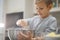 Child cooking at the kitchen. White boy stirring dough for a cookie. Kid is mixing ingredients for a cake in the steel bowl. 8