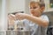 Child cooking at the kitchen. White boy stirring dough for a cookie. Kid is mixing ingredients for a cake in the steel bowl. 8