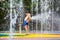 Child cooling off in public fountain