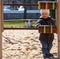 Child counts toy wooden rings on the playground