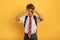 Child cries because does not want to go to school. Yellow background