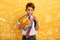 Child cries because he has a lot of school homework. Emotional expression. Yellow background