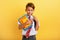 Child cries because he has a lot of school homework. Emotional expression. Yellow background