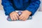 Child crumples slime. Close up of hands. Process of making slime. Blue magic glitter slime on a white background.