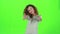 Child curly haired shows thumbs up. Green screen