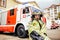 Child, cute boy, dressed in fire fighers cloths in a fire station with fire truck, childs dreamed profession