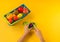 A child cuts a plastic fruit on a board