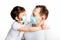 Child and dad in blue medical masks and white t-shirts hugging and looking at each other on white background. Coronavirus
