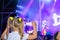 A child dances at a popular music festival. View from the back. Party and disco for young people. Little girl having fun at a
