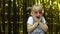 Child dancing, show amazement, fooling around, smiling. Girl posing on background with foil curtain