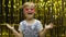 Child dancing, show amazement, fooling around, smiling. Girl posing on background with foil curtain