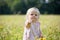 Child at dandelion meadow in summer