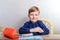 Child in a dark shirt sitting at a Desk