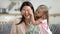 Child daughter make surprise close eyes of mommy presenting flowers