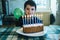 Child in the day of his ninth birthday blowing the candles on th