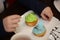 Child decorates the muffins with sprinkling in the kitchen