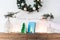 Child decorating fireplace with `Happy christmas` sign