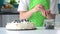 Child decorating pavlova meringue with blueberries