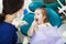 Child at dentist office sits in comforatble chair