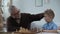 Child development, grandfather teaching grandson to play chess, family leisure