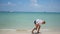 Child doing gymnastics on the beach on a sunny day