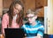 Child doing homework with foster parent in kitchen