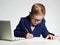 Child doing homework.Young business boy in office.kid in glasses writing pen