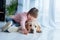 Child with down syndrome playing with Labrador retriever dog